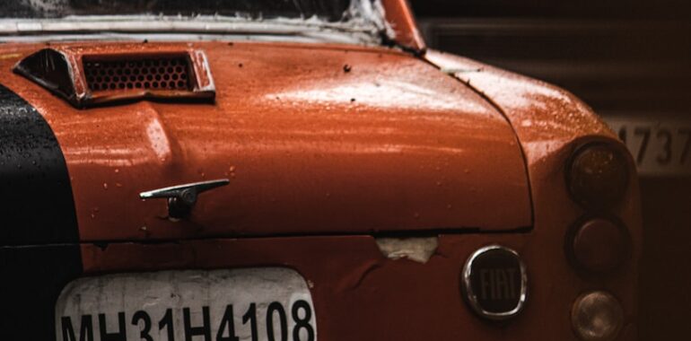 an orange car with a black stripe on it