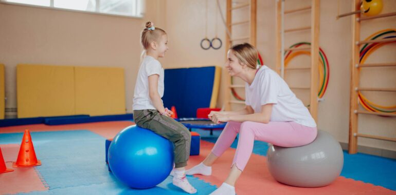 A Mother and Daughter Sitting on Exercise Balls