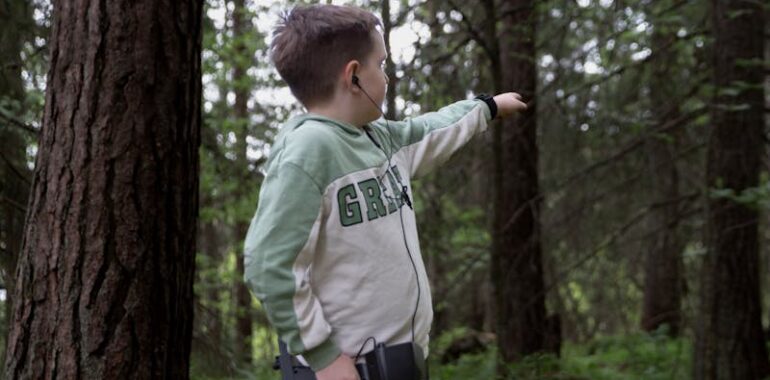 Boy with Metal Detector in Forest