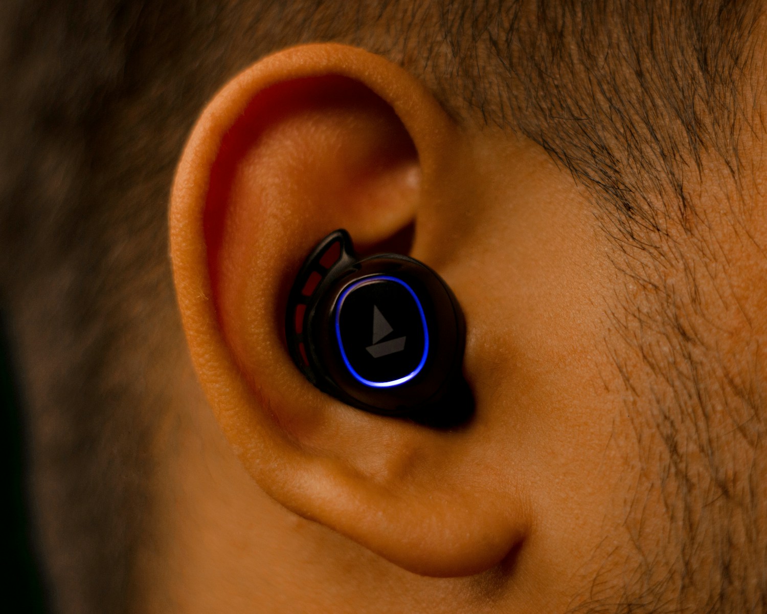 a close up of a person wearing a pair of earphones